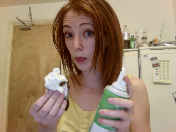 a woman holding a cup and a toothbrush Sel