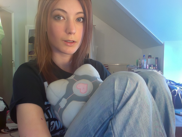 a woman sitting on a bed with a stuffed animal