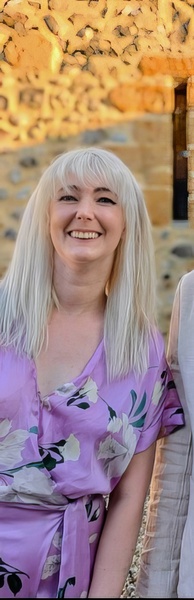 a woman with blonde hair and a purple dress