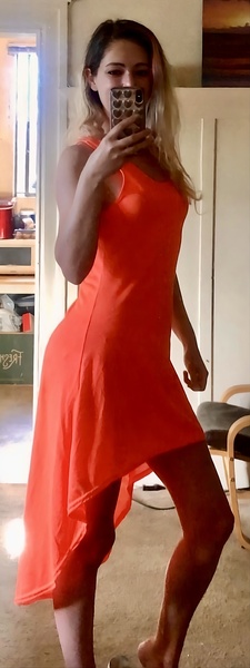 a woman in a red dress taking a selfie