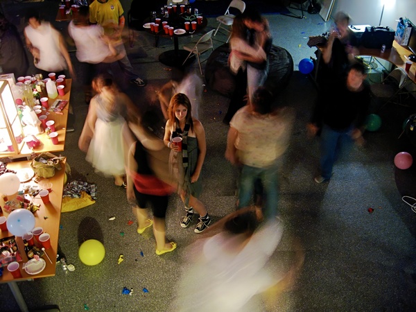 a group of people dancing around a room