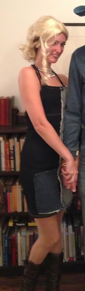 a man and woman are standing in front of a book shelf Hat