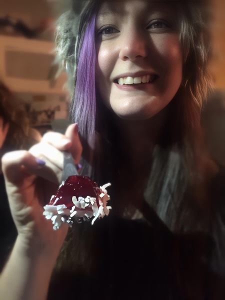 a woman with purple hair holding a don