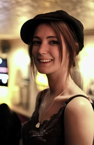 a woman with a hat and a smile