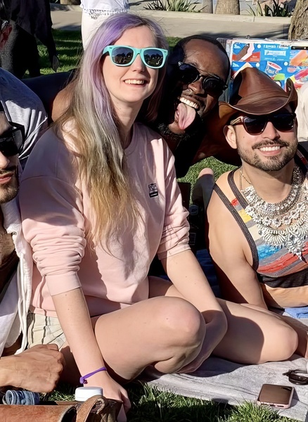 a group of people sitting on a blanket