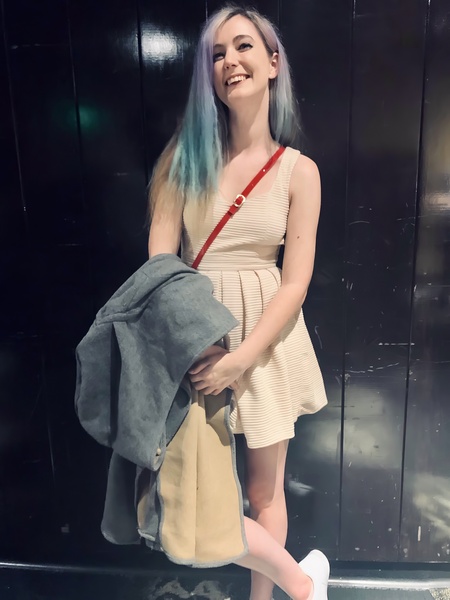 a woman with blue hair and a backpack