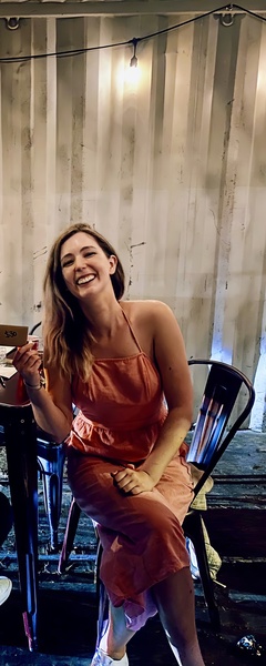 a woman sitting at a table with a plate of food