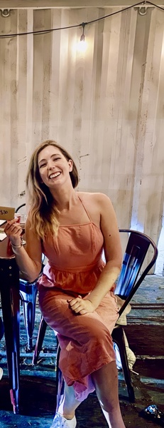 a woman sitting at a table with a plate of food