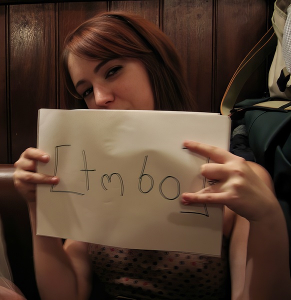 a woman holding a piece of paper with the word love written on it