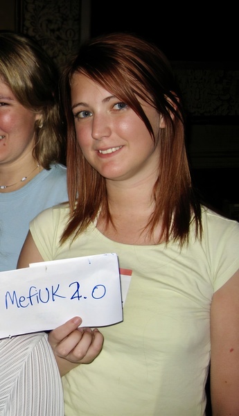 two women holding a sign that says'merk '