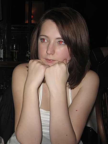 a woman sitting at a table with a plate of food