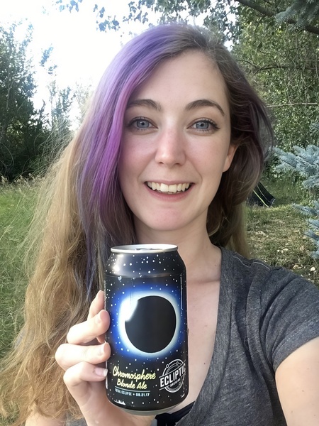 a woman holding a can of beer in her hand