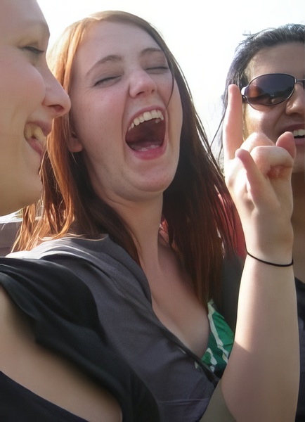 a group of young women are laughing and having a laugh