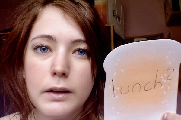 a woman holding a paper plate with writing on it