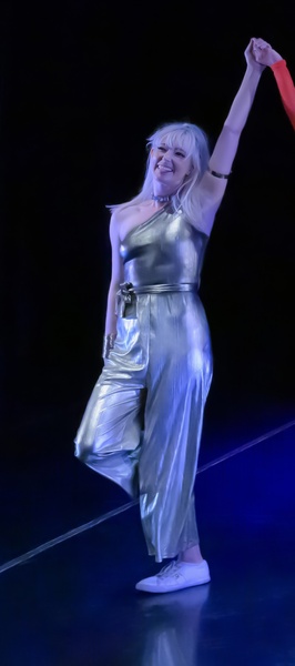 a woman in a silver jumpsuit