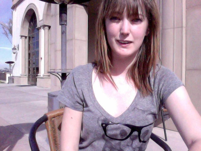 a woman sitting on a chair outside