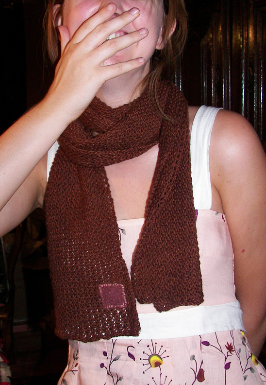 a woman wearing a brown scarf