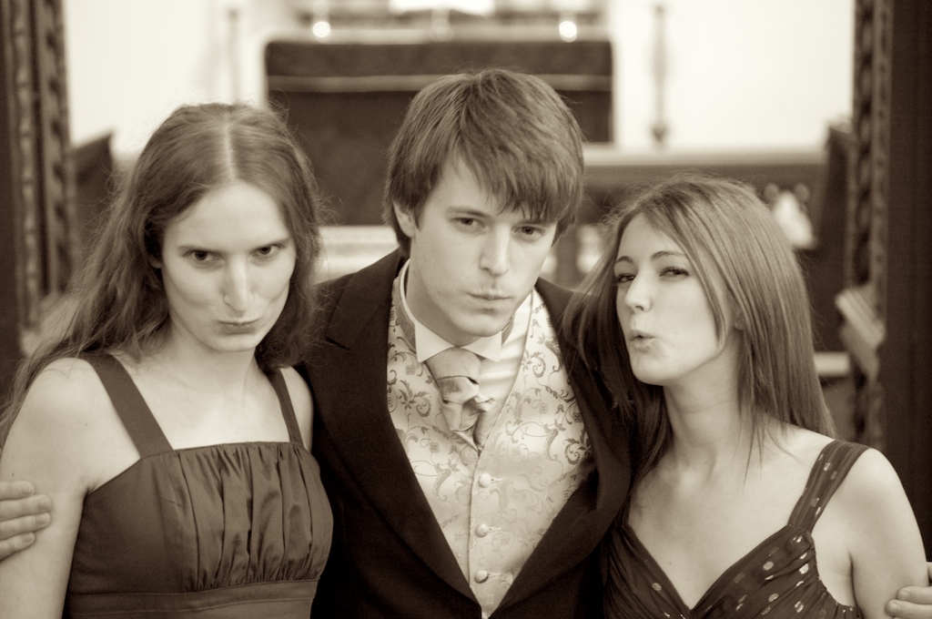 three young people are posing for a picture