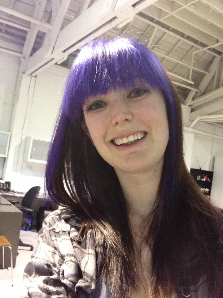 a woman with purple hair and a black shirt