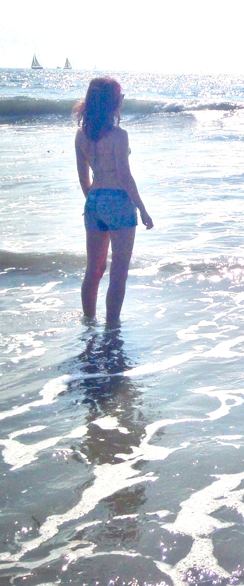 a woman in a bikini standing in the water