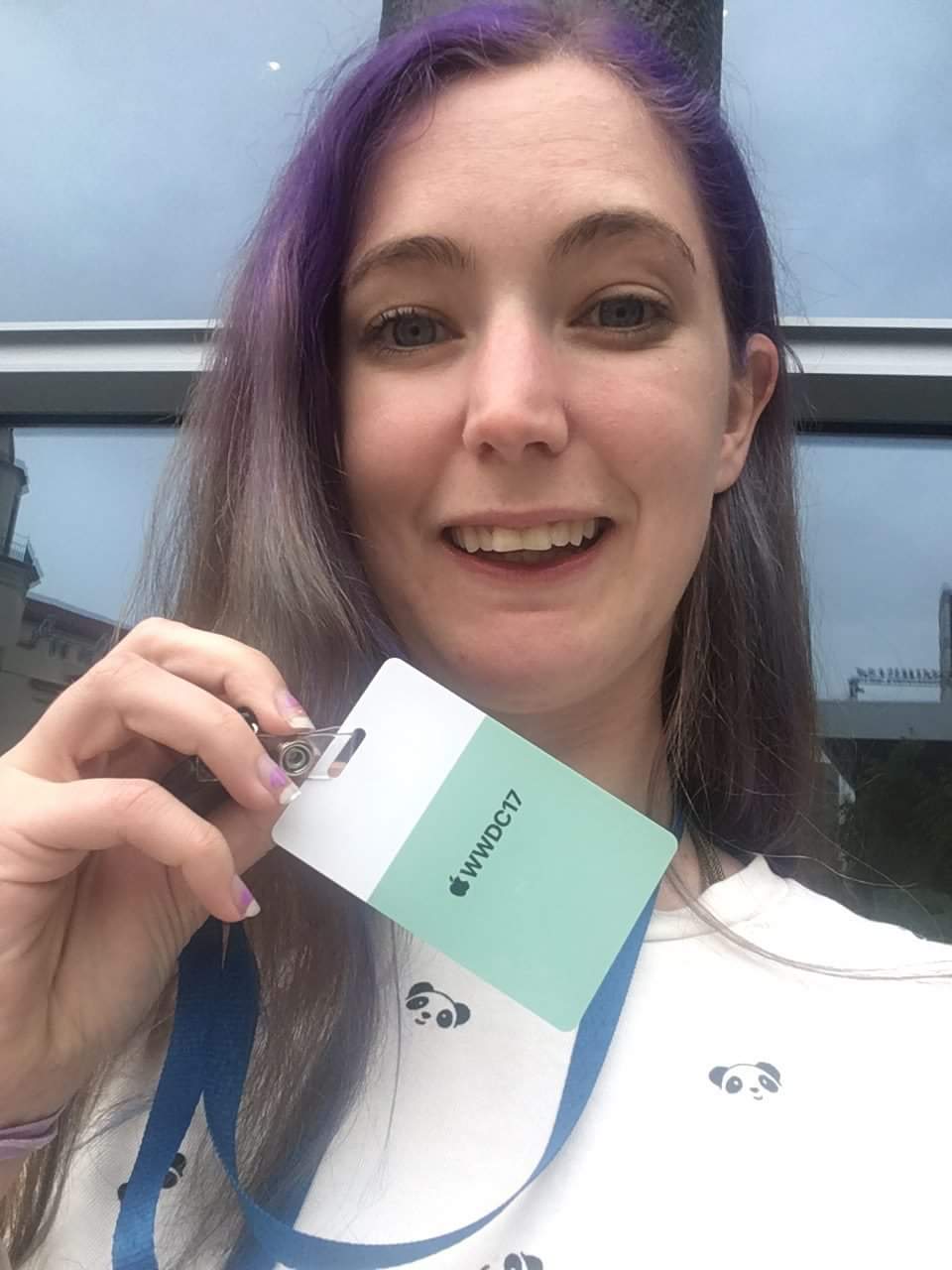 a woman with purple hair holding a green and white card