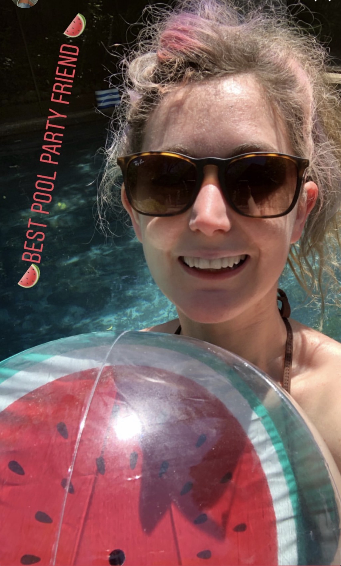 a woman holding a watermelon in a pool