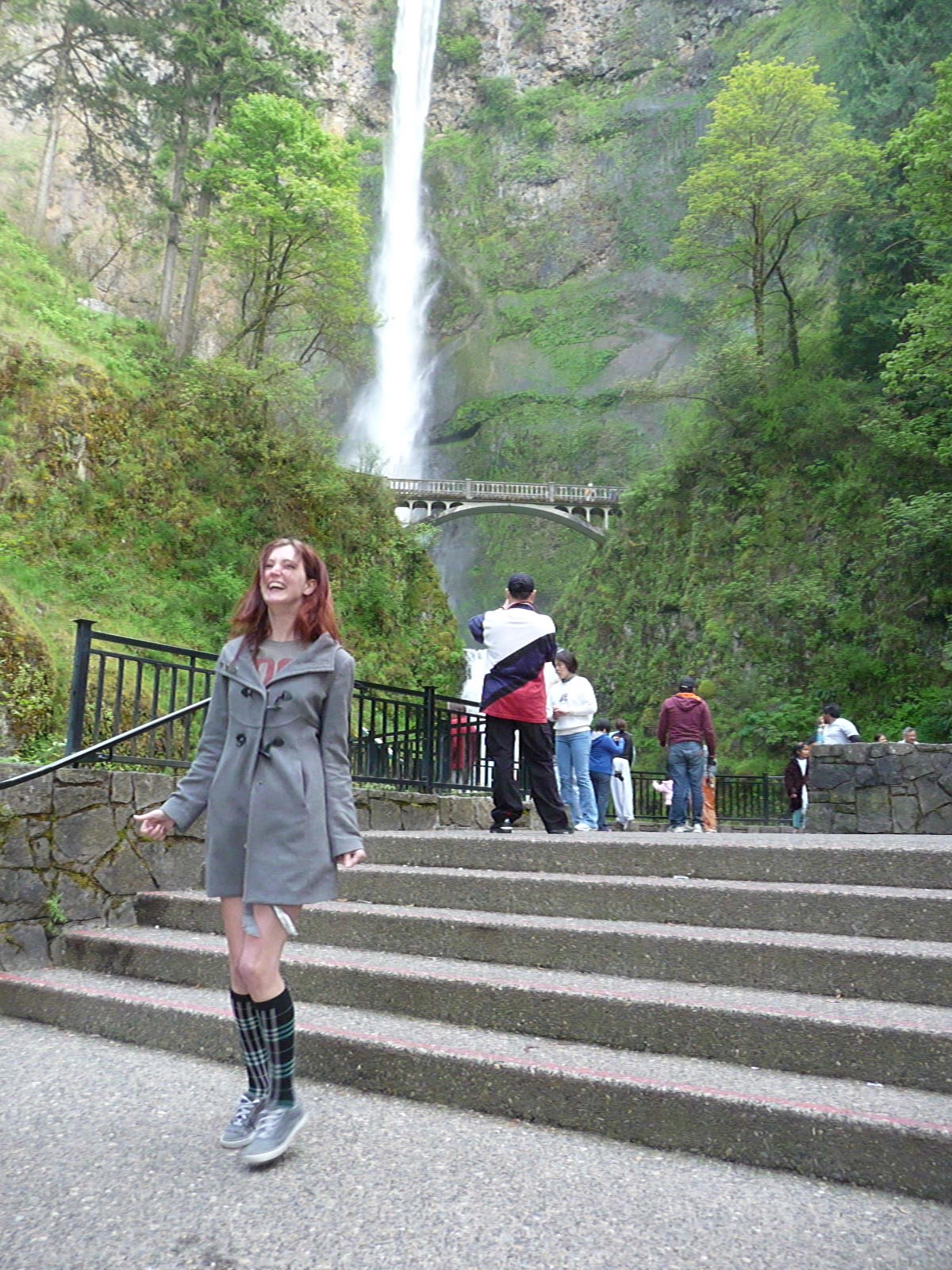 a woman in a gray coat is walking up some stairs arlene

Ri
ie
(E