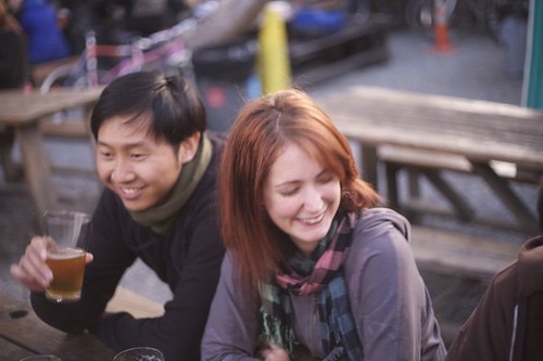 three people sitting at a table with drinks