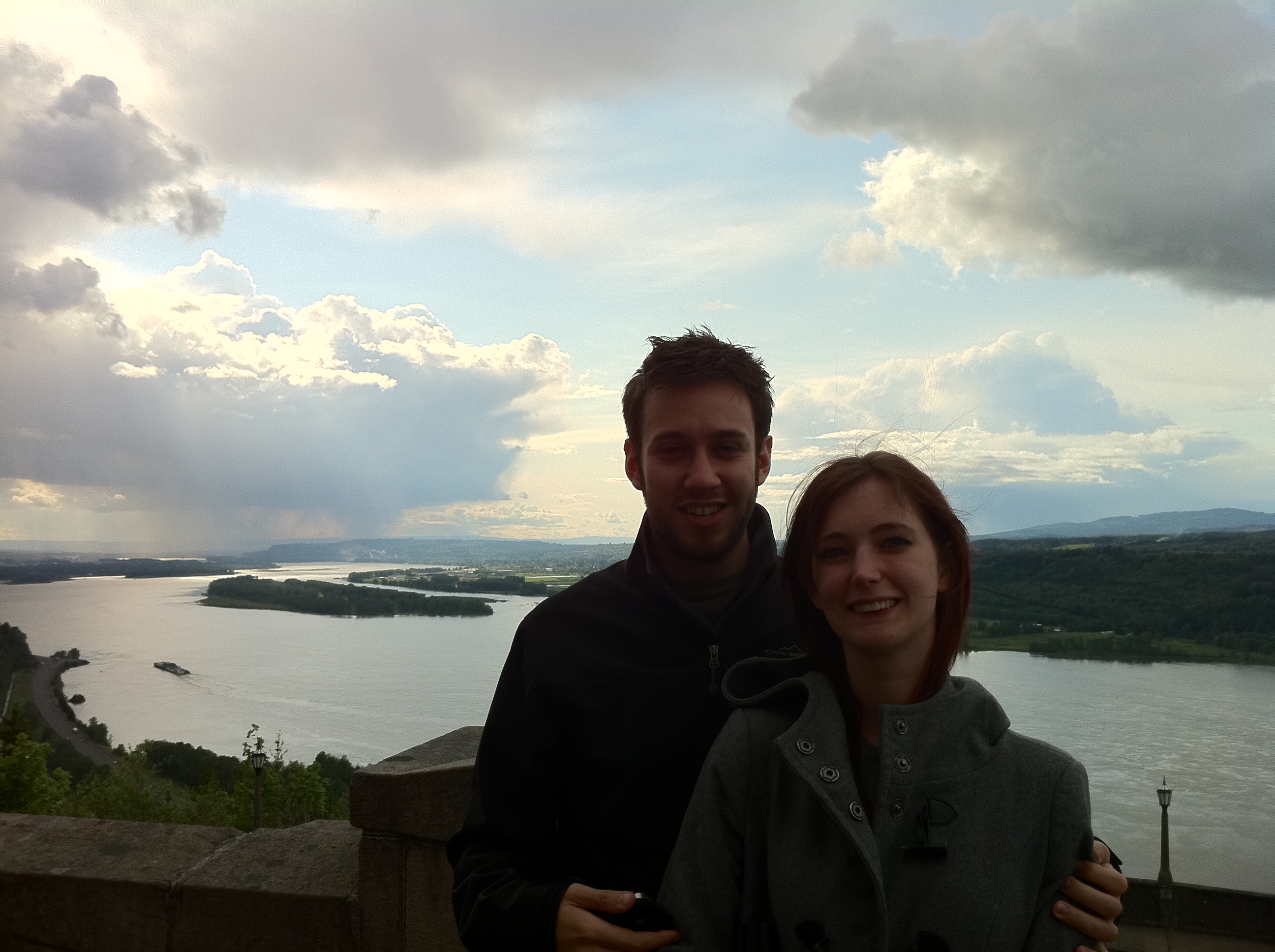 a man and woman standing on a wall