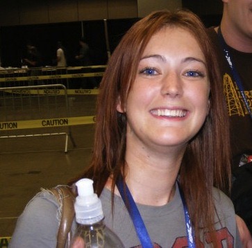 a man and woman holding up a bottle of water