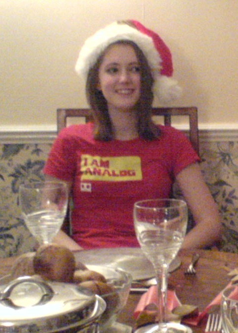 a woman sitting at a table with a plate of food