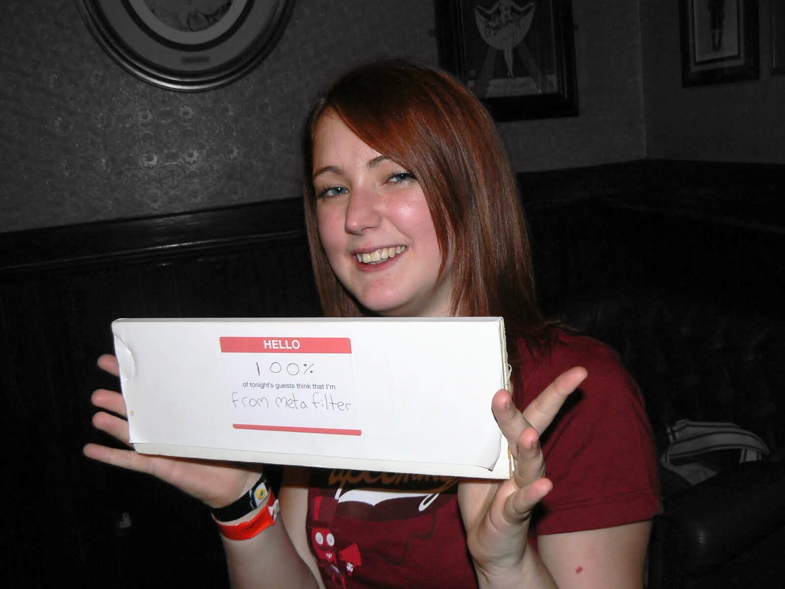 a woman holding a box of pizza