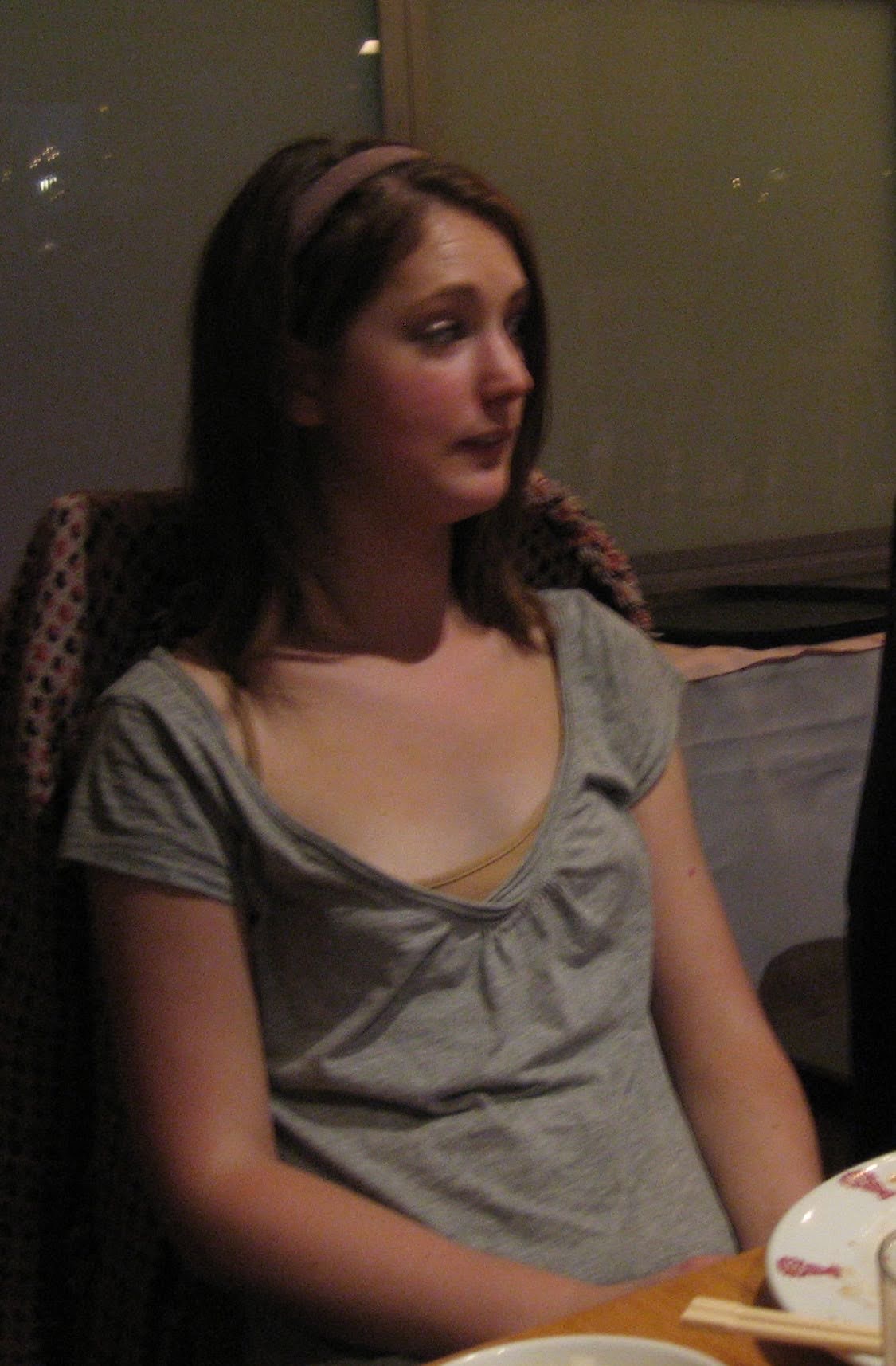 a woman sitting at a table with a plate of food