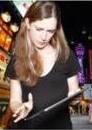 a woman is cutting a cake with a knife