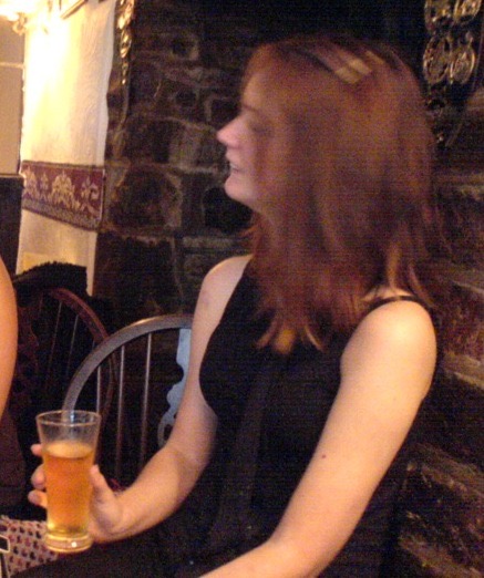 two women sitting at a table with drinks