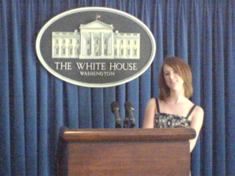 a woman standing at a podium in front of a blue curtain THE WHITE HOUSE

WASHINGTON