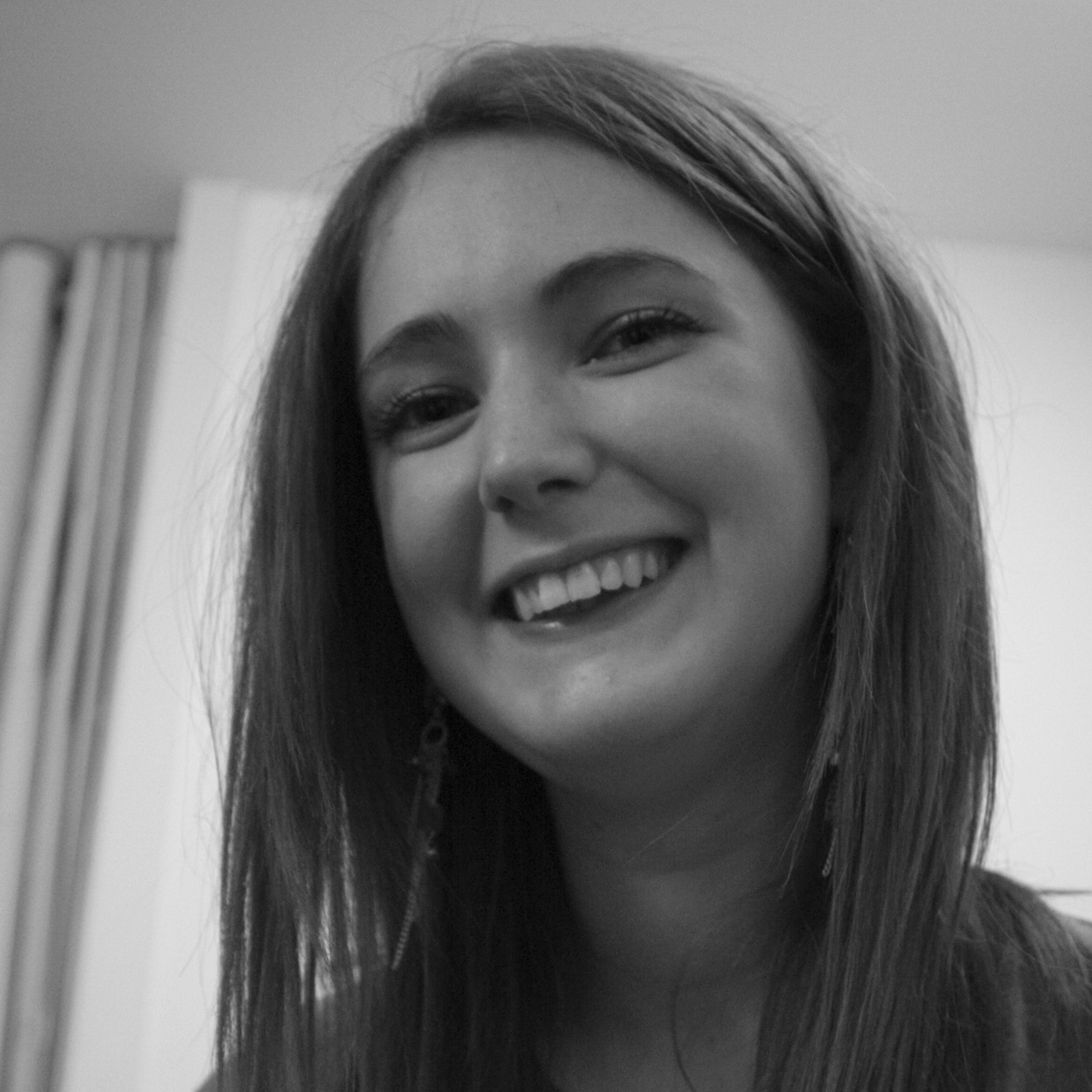 a woman with long hair smiling at the camera