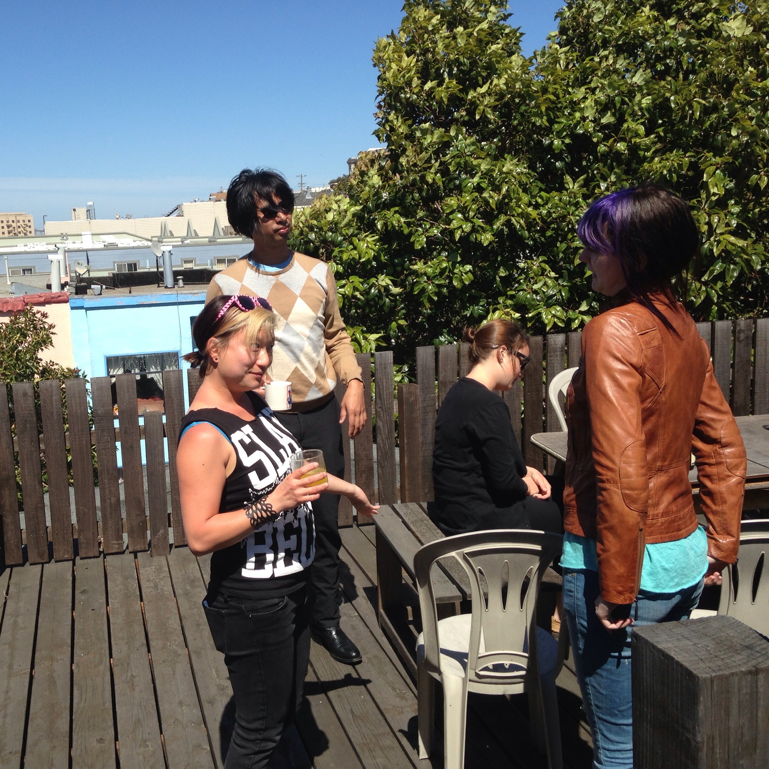 a group of people standing on a wooden deck