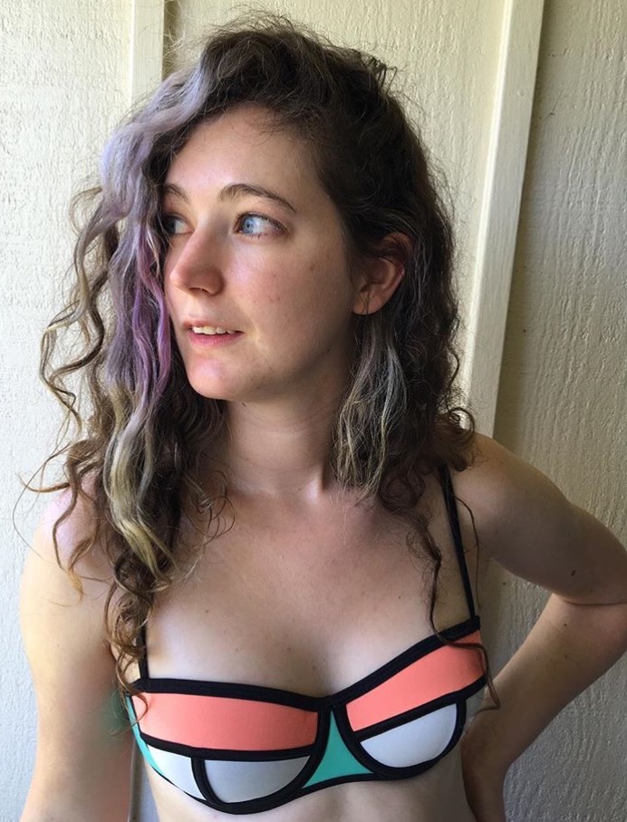 a woman with long hair wearing a colorful bikini