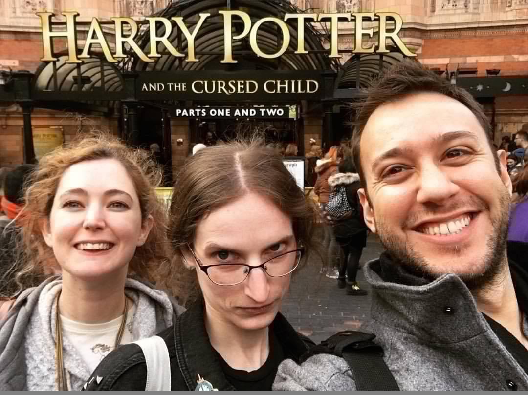 a man and woman are posing for a picture anp THE CURSED CHILD

_ PARTS ONE AND TWo jf!