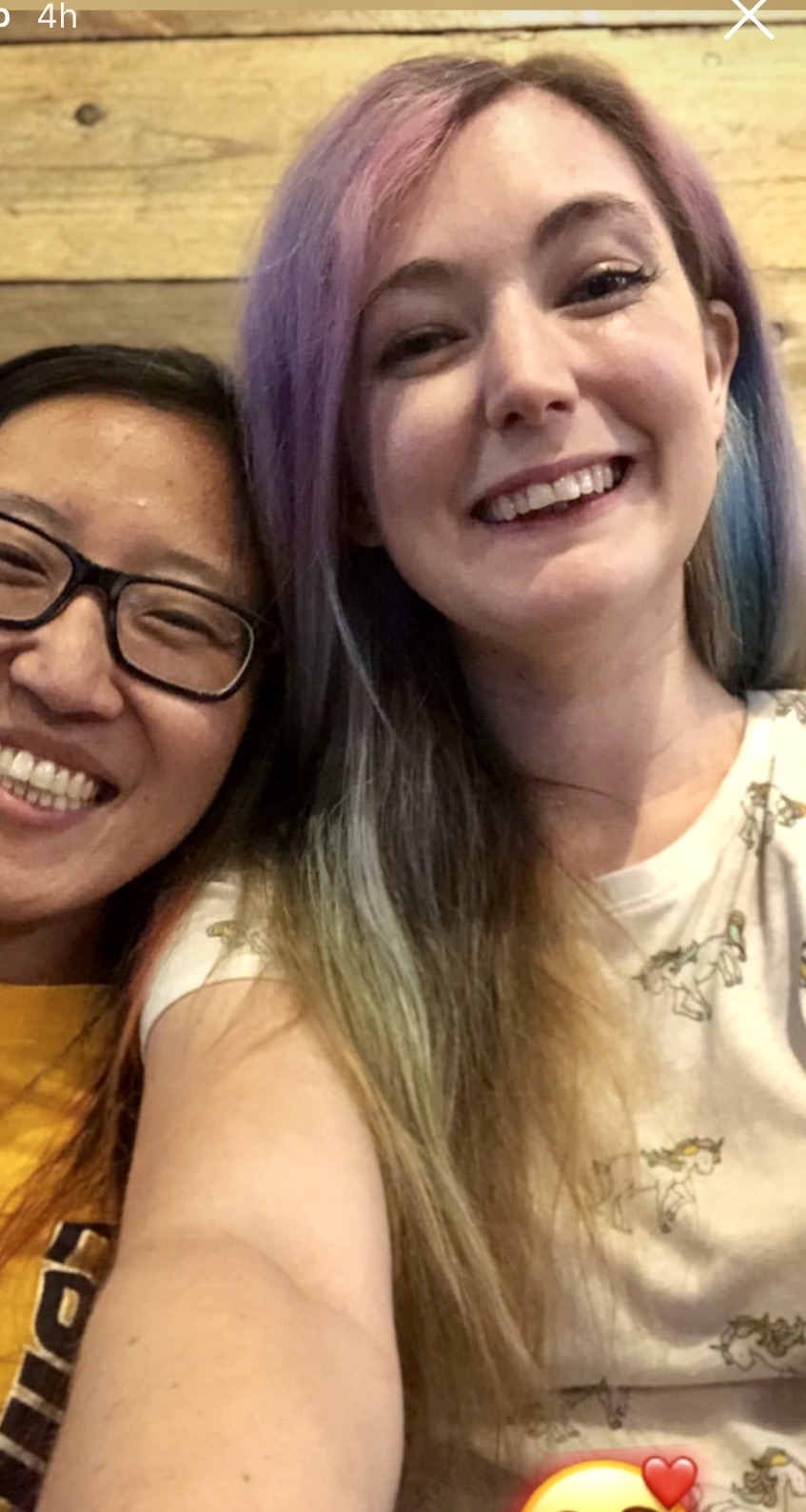 two women sitting on a couch smiling