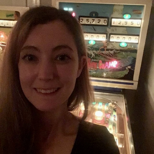 a woman standing in front of a vending machine