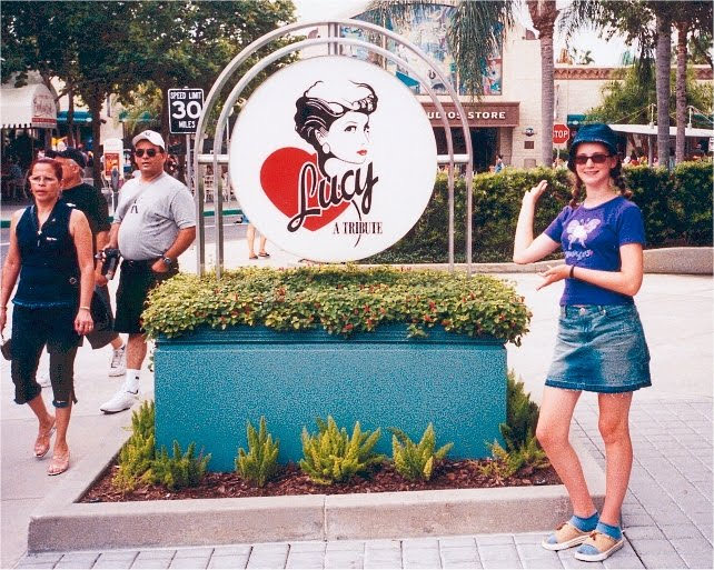 a woman standing in front of a sign