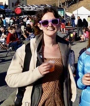 two women walking down the street holding drinks