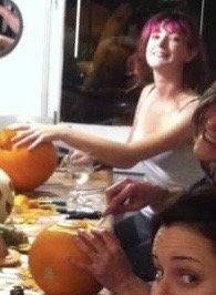 a group of people sitting around a table with food