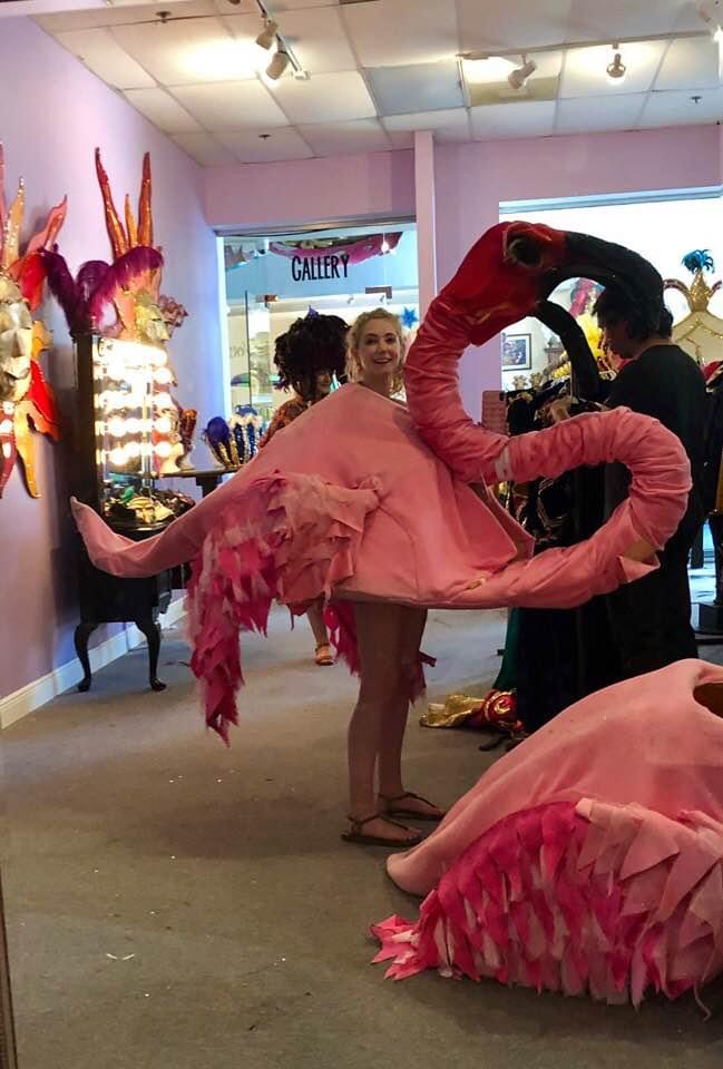 a woman in pink dress dancing with a man in a black suit