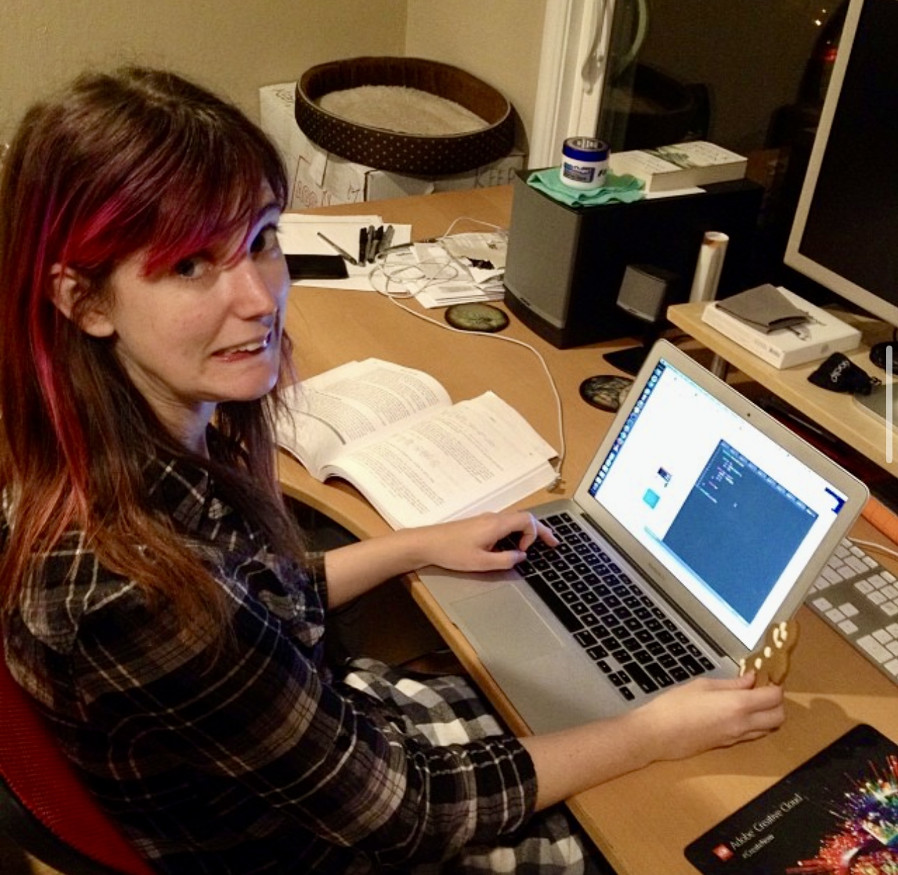 a woman sitting at a desk with a laptop