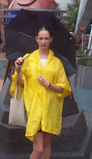 a woman in a yellow raincoat