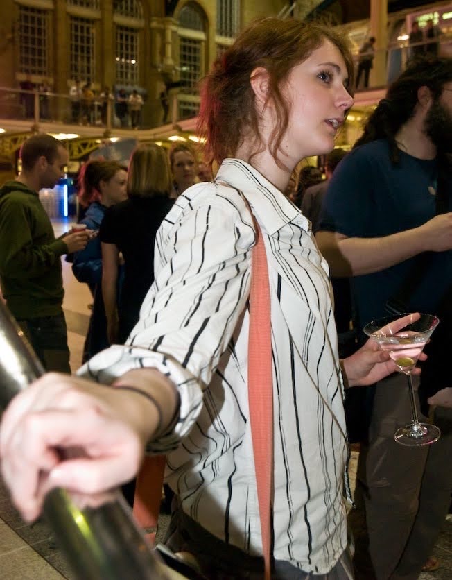 a woman in a striped shirt and tie is walking down the street