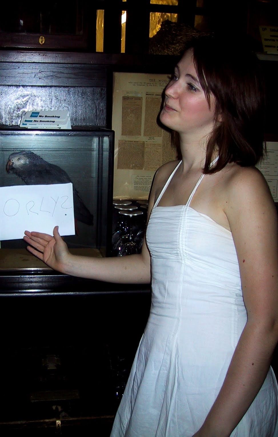 a woman in a white dress holding a piece of paper